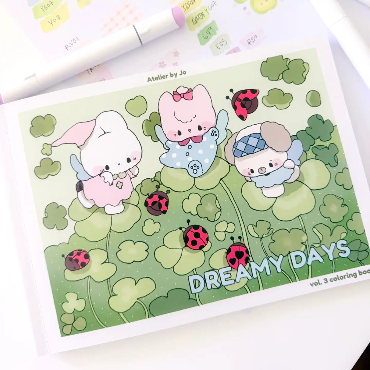 🍓🐞 Drift into a World of Dreamy Days with Coloring Book Vol. 3! 🧵✨

Step into a playful little world stitched together with lucky ladybugs, vintage buttons, gingham bows, and cozy daydreams. Featuring 25 original, full-page illustrations, Dreamy Days Vol. 3 follows Cotton and Pluto through charming kitchens, clover-filled gardens, strawberry picnics, and delightfully kitschy corners overflowing with nostalgic treasures and cheerful details.

Inspired by retro trinkets, handmade keepsakes, and soft countr