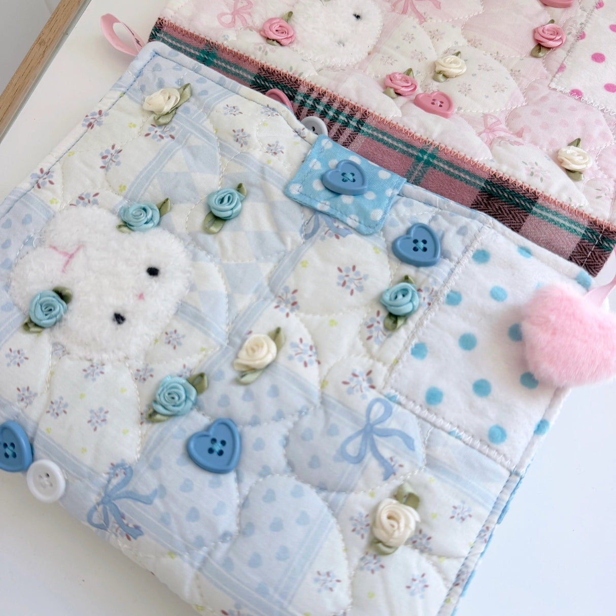 Elevate your journaling experience with these soft and cozy journal covers, designed to protect and personalize your daily diary. Each cover features beautiful blue and pink patterned fabric with thoughtfully sewn details and a secure metal button clasp to keep your pages safe. Includes matching ribbon bookmarks for easy navigation. Available in both A5 and A6 sizes to fit your preferred journal dimensions. The perfect companion for your daily routine and creative practice.