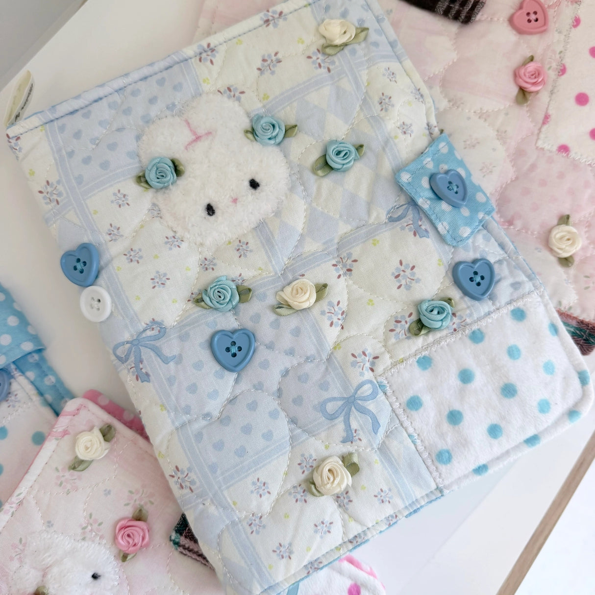 Elevate your journaling experience with these soft and cozy journal covers, designed to protect and personalize your daily diary. Each cover features beautiful blue and pink patterned fabric with thoughtfully sewn details and a secure metal button clasp to keep your pages safe. Includes matching ribbon bookmarks for easy navigation. Available in both A5 and A6 sizes to fit your preferred journal dimensions. The perfect companion for your daily routine and creative practice.
