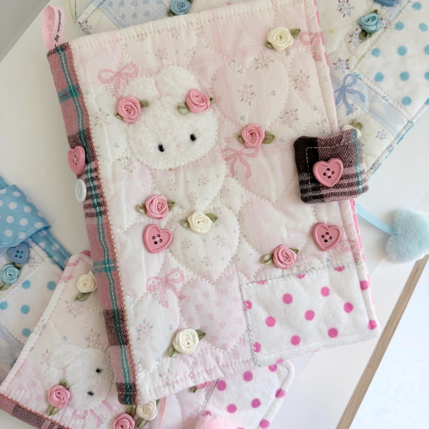 Elevate your journaling experience with these soft and cozy journal covers, designed to protect and personalize your daily diary. Each cover features beautiful blue and pink patterned fabric with thoughtfully sewn details and a secure metal button clasp to keep your pages safe. Includes matching ribbon bookmarks for easy navigation. Available in both A5 and A6 sizes to fit your preferred journal dimensions. The perfect companion for your daily routine and creative practice.