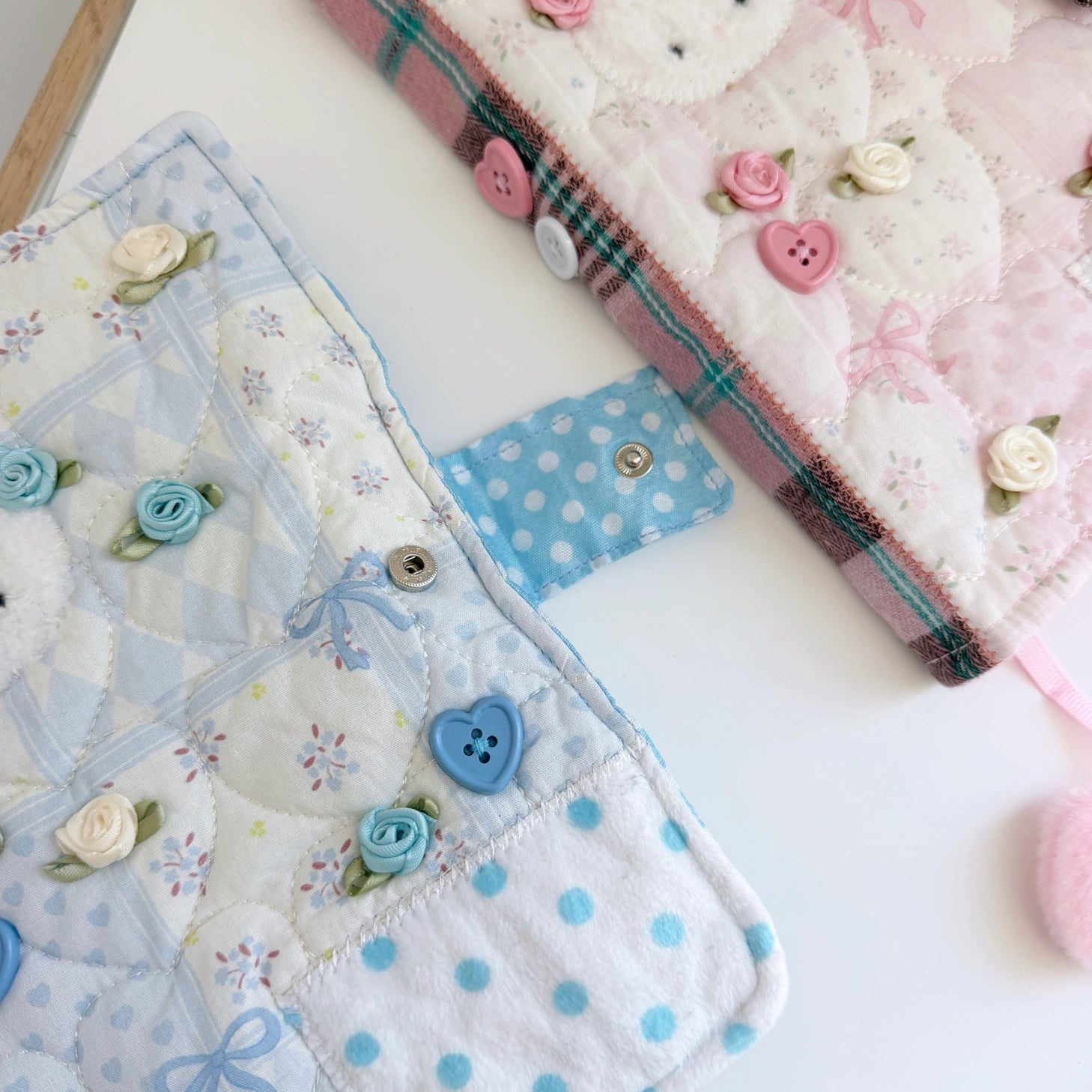 Elevate your journaling experience with these soft and cozy journal covers, designed to protect and personalize your daily diary. Each cover features beautiful blue and pink patterned fabric with thoughtfully sewn details and a secure metal button clasp to keep your pages safe. Includes matching ribbon bookmarks for easy navigation. Available in both A5 and A6 sizes to fit your preferred journal dimensions. The perfect companion for your daily routine and creative practice.
