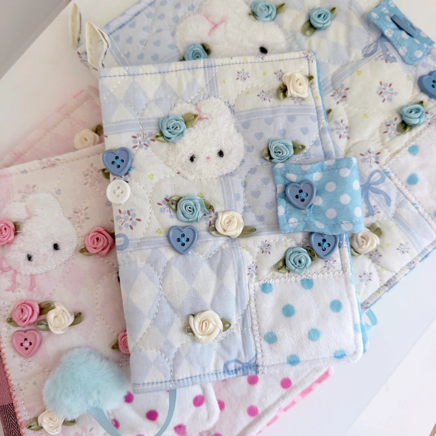 Elevate your journaling experience with these soft and cozy journal covers, designed to protect and personalize your daily diary. Each cover features beautiful blue and pink patterned fabric with thoughtfully sewn details and a secure metal button clasp to keep your pages safe. Includes matching ribbon bookmarks for easy navigation. Available in both A5 and A6 sizes to fit your preferred journal dimensions. The perfect companion for your daily routine and creative practice.