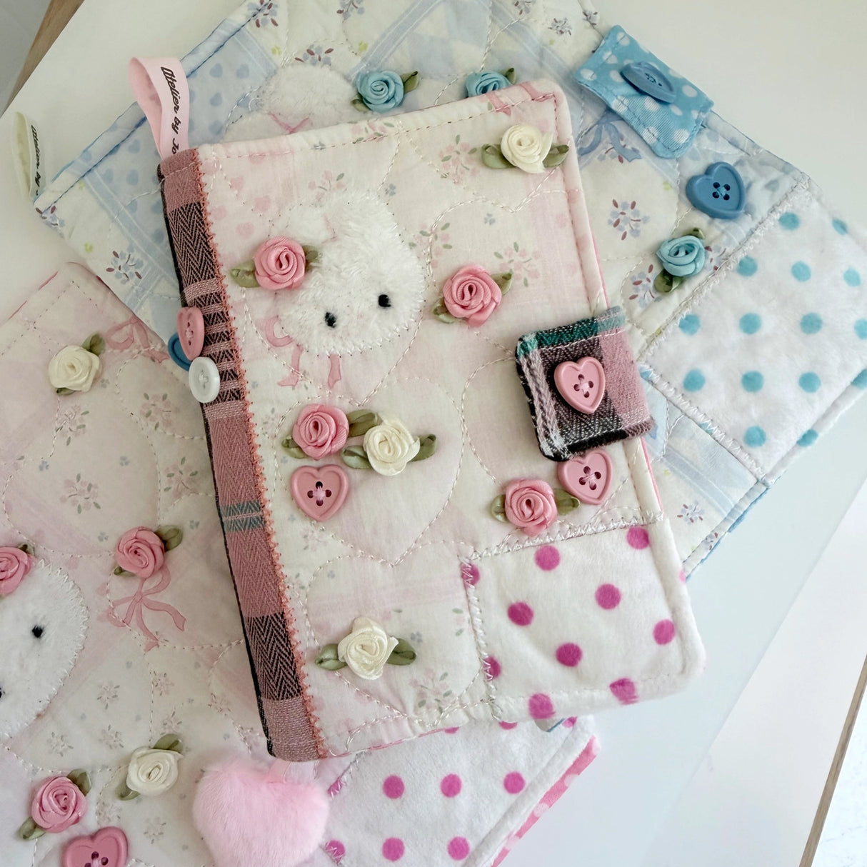 Elevate your journaling experience with these soft and cozy journal covers, designed to protect and personalize your daily diary. Each cover features beautiful blue and pink patterned fabric with thoughtfully sewn details and a secure metal button clasp to keep your pages safe. Includes matching ribbon bookmarks for easy navigation. Available in both A5 and A6 sizes to fit your preferred journal dimensions. The perfect companion for your daily routine and creative practice.