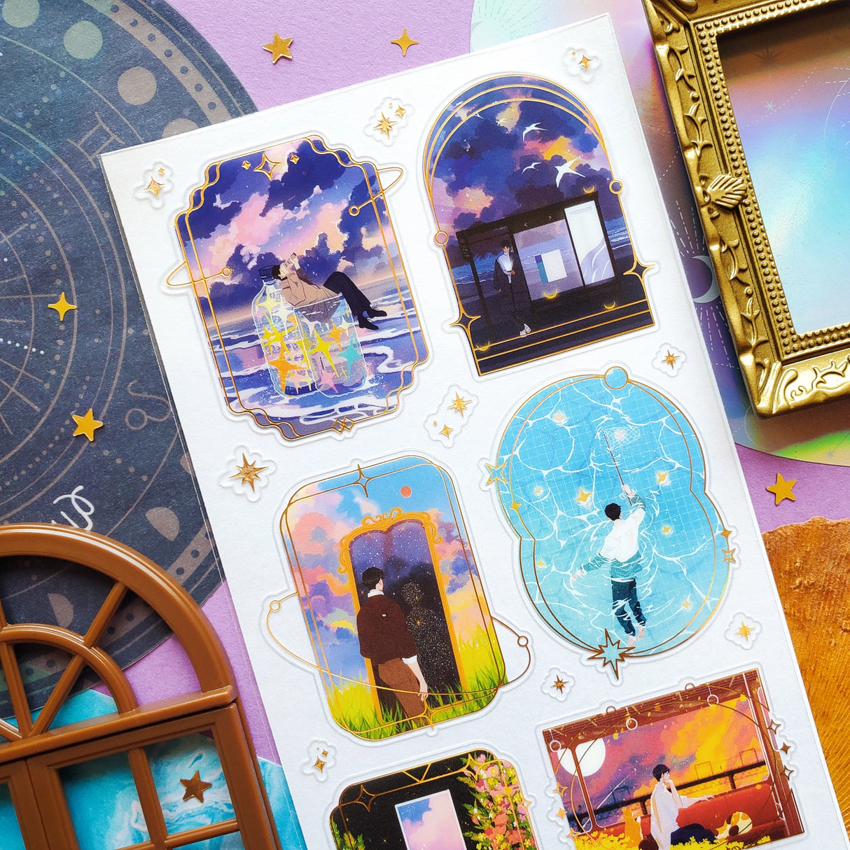 🌙⭐ Wanna get even further away? @9jedit’s got you covered with this stellar celestial set. Sometimes we can only escape in our daydreams and why would we want that to be ordinary? Think cozy reads under crescent moons, ferris wheel rides through cotton candy skies, and portals to worlds that aren’t planet earth. Take us away!

Art by: @9jedit

Top Coating: Gold foil

Adhesive Layer: PVC (plastic)

Backing Layer: Clear PET

6.69" x 3.54". Weight - 0.03lbs.

1 sheet included