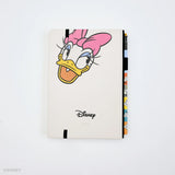 This medium notebook includes 160 pages of 100GSM blank paper and a matte hardcover featuring Donald Duck and Daisy Duck. It also has a built-in pencil holster that comes loaded with a Donald Duck Blackwing pencil.