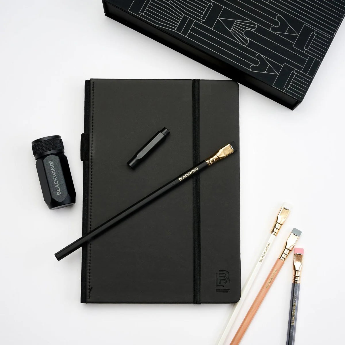 A great way to get started on the Blackwing journey. Give the gift of high-quality Blackwing pencils, paper &amp; accessories — all in one box set.

Includes a Medium Black A5 Slate Notebook, each of our core pencils (602, Matte, Pearl, Natural), One-Step Long Point Sharpener, and Point Guard -- all packaged in a box set.