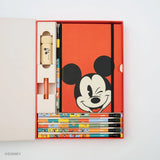 This Notebook Essentials Set includes 6 Blackwing pencils featuring Mickey Mouse, Minnie Mouse, Pluto, Goofy, Donald Duck, and Daisy Duck. It also includes a Mickey Mouse Pencil Sharpener, a Mickey Mouse Point Guard, and a medium Mickey & Minnie Mouse notebook with blank paper.
