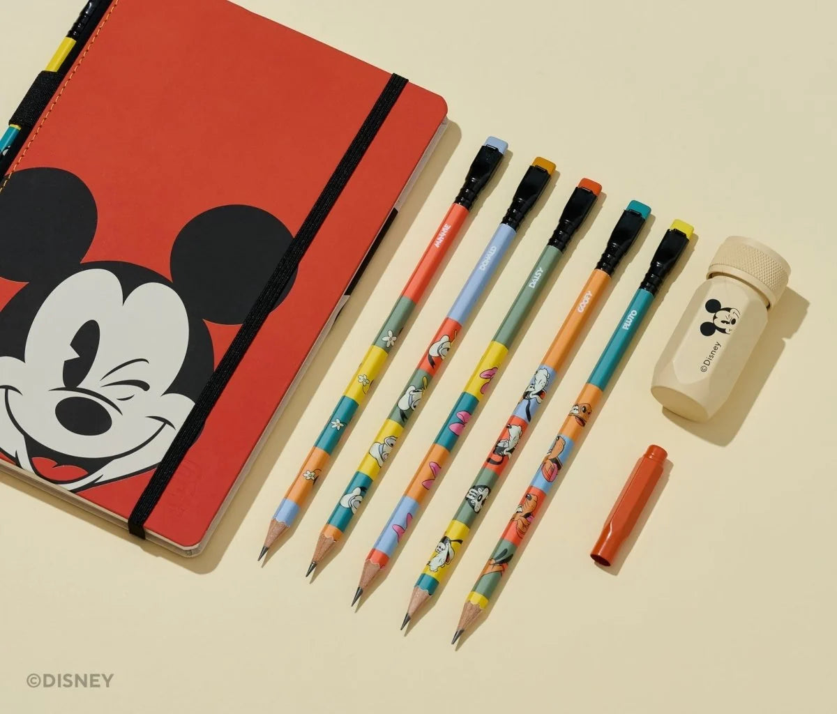 This Notebook Essentials Set includes 6 Blackwing pencils featuring Mickey Mouse, Minnie Mouse, Pluto, Goofy, Donald Duck, and Daisy Duck. It also includes a Mickey Mouse Pencil Sharpener, a Mickey Mouse Point Guard, and a medium Mickey & Minnie Mouse notebook with blank paper.