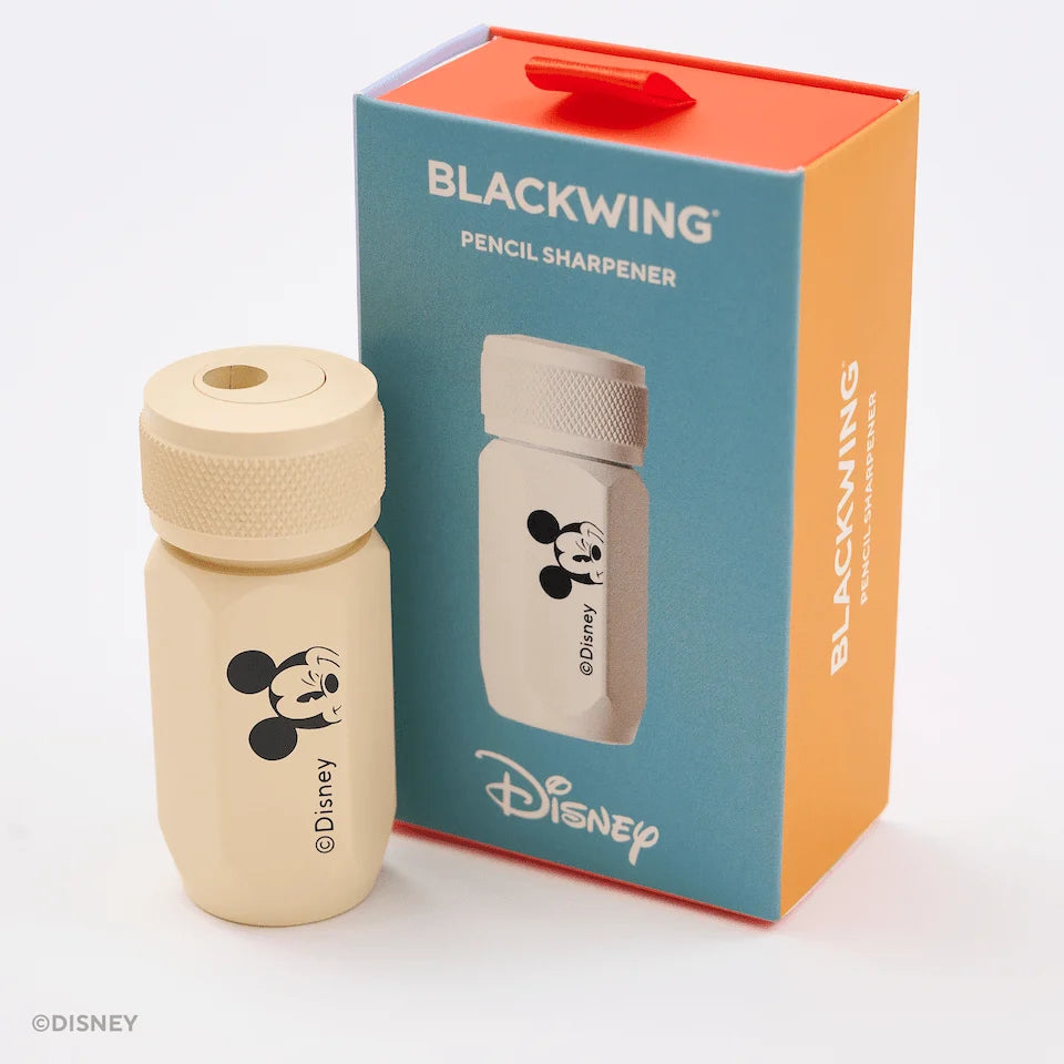 This Notebook Essentials Set includes 6 Blackwing pencils featuring Mickey Mouse, Minnie Mouse, Pluto, Goofy, Donald Duck, and Daisy Duck. It also includes a Mickey Mouse Pencil Sharpener, a Mickey Mouse Point Guard, and a medium Mickey & Minnie Mouse notebook with blank paper.