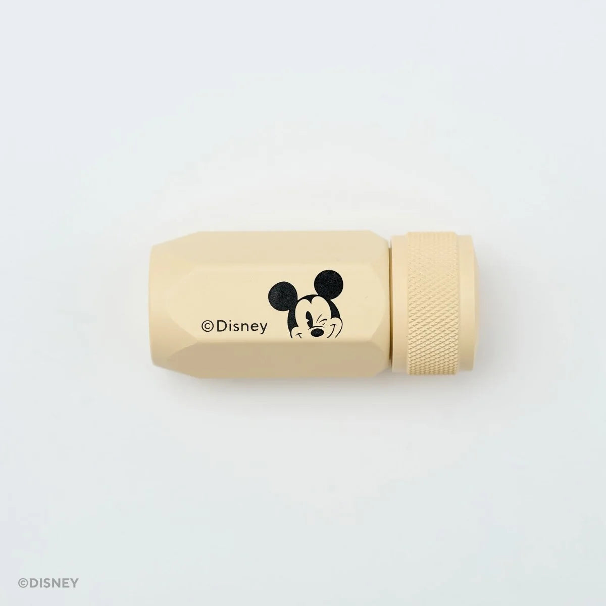 This premium pencil sharpener is made of machined aluminum and sharpens your pencils to a strong, curved point. The cream-colored sharpener features a Mickey Mouse illustration and printed Disney logo on the side in black.