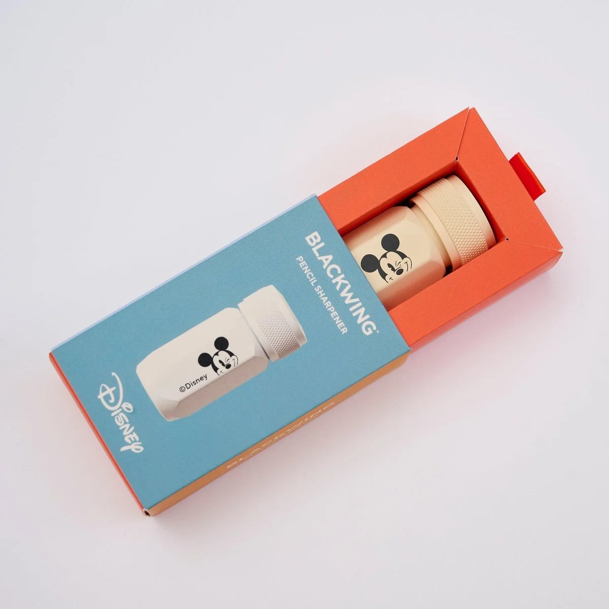 This premium pencil sharpener is made of machined aluminum and sharpens your pencils to a strong, curved point. The cream-colored sharpener features a Mickey Mouse illustration and printed Disney logo on the side in black.