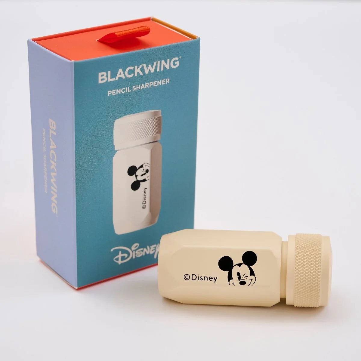 This premium pencil sharpener is made of machined aluminum and sharpens your pencils to a strong, curved point. The cream-colored sharpener features a Mickey Mouse illustration and printed Disney logo on the side in black.