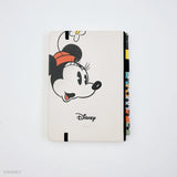 This medium notebook includes 160 pages of 100GSM blank paper and a matte hardcover featuring Mickey and Minnie Mouse. It also has a built-in pencil holster that comes loaded with a Mickey Mouse Blackwing pencil.