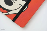 This medium notebook includes 160 pages of 100GSM blank paper and a matte hardcover featuring Mickey and Minnie Mouse. It also has a built-in pencil holster that comes loaded with a Mickey Mouse Blackwing pencil.