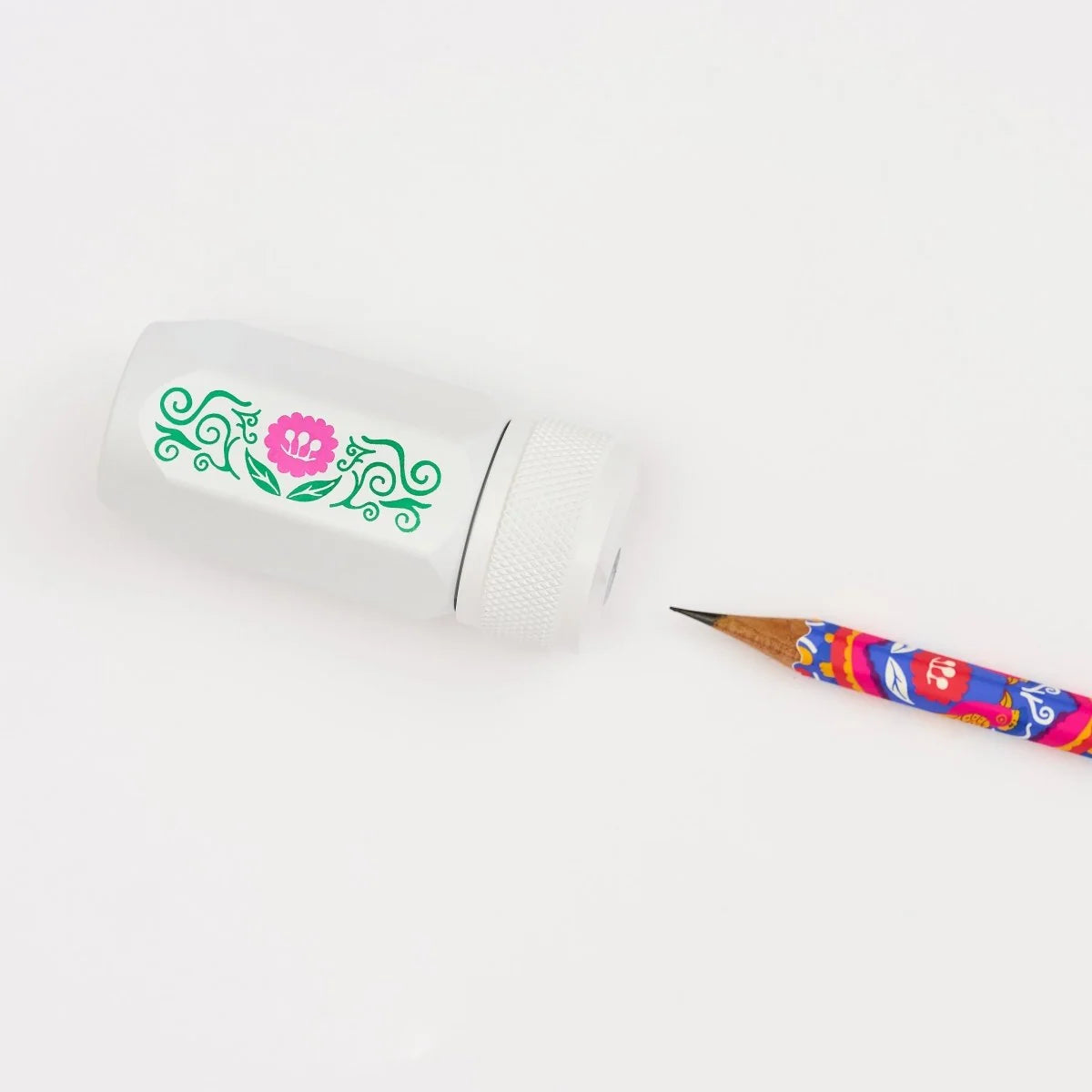 Volume 143 is our tribute to Frida Kahlo. The model number 143 is a nod to the 143 paintings commonly attributed to her over the course of her life.

This limited-edition Volume 143 Blackwing Long Point One-Step Sharpener comes in white with a Frida Kahlo-inspired floral design on the side. The sharpener body is made of durable, machined aluminum, and the sharpening unit features a premium German steel blade for consistent pencil sharpening. The canister can hold three fresh pencil sharpenings before needin