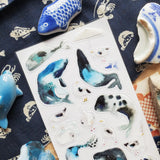 🐋☂️ Breezy and full of seaside charm, @martyna.czub’s watercolor whales and gulls make quite the charming coastal crew. With curious expressions, tiny umbrellas, rain boots, and a few delightfully dramatic whale poses, this playful sheet perfectly captures the magic of a windswept day by the sea.

Art by: @martyna.czub