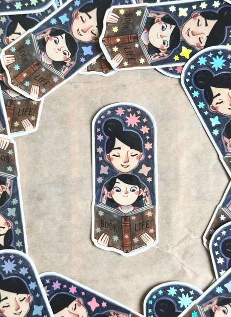 Bring the magic of storytime to life with our enchanting Mom and Kid Reading Sticker! Crafted with love and attention to detail, this holographic vinyl sticker captures a heartwarming scene of a mom and child engrossed in a book together that your customers will love!&nbsp;

Features: Size: 3.5 inches tall, 1.5 inches wide

Material: Premium vinyl with a captivating holographic finish