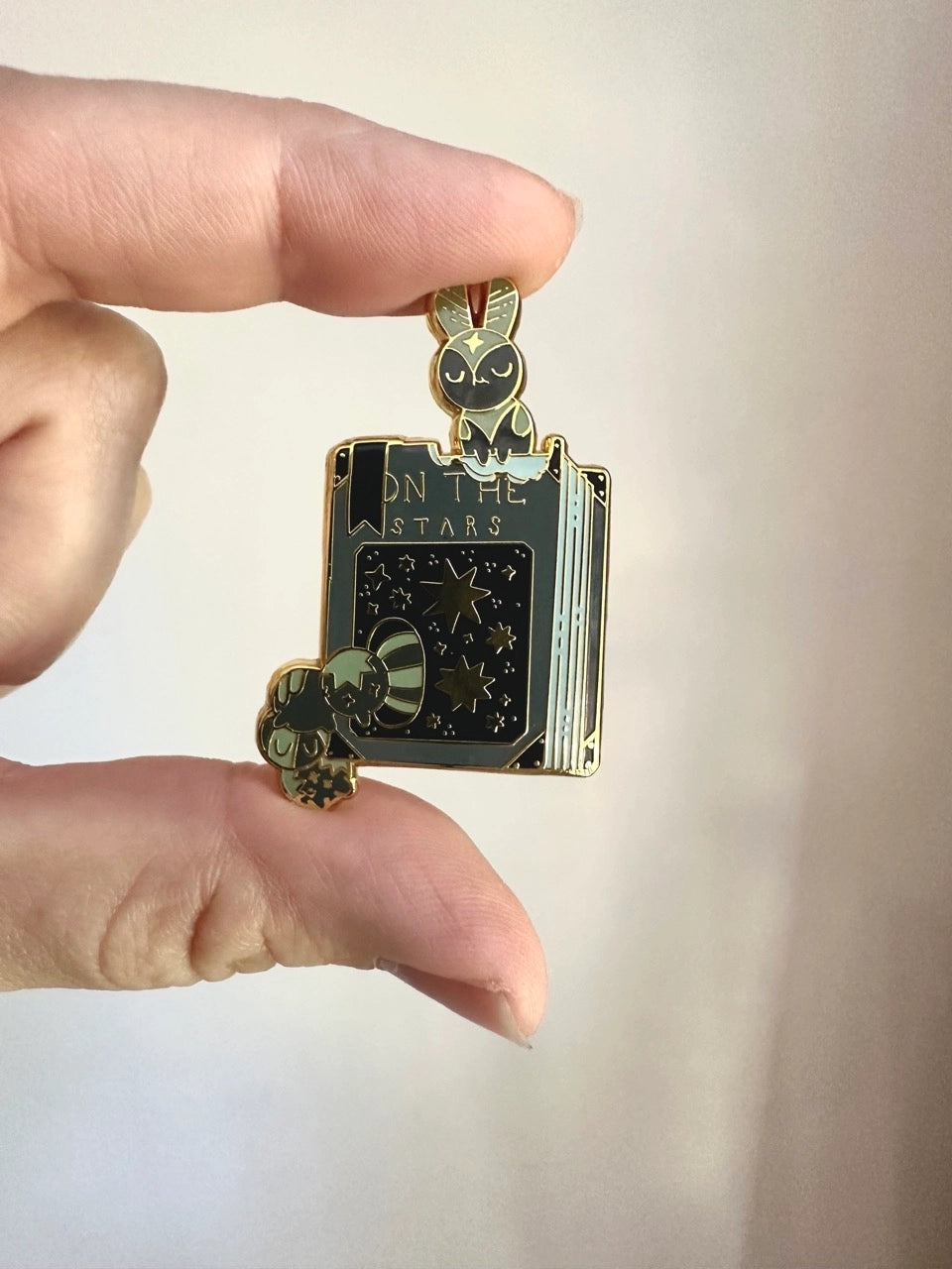 These pins are a lovely, small and cute piece to show off on your clothes, book bags, or wherever you show off your pins!

1.65 inches tall, gold metal lapel pin with "hard" enamel colors. Black rubber clasps. Packaged in a small plastic bag with a card backing.