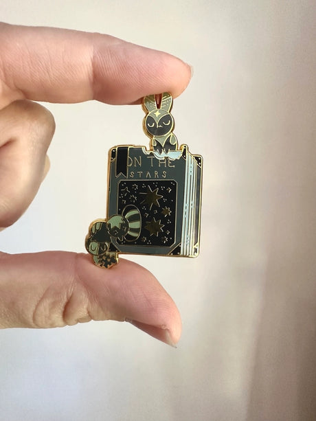 These pins are a lovely, small and cute piece to show off on your clothes, book bags, or wherever you show off your pins!

1.65 inches tall, gold metal lapel pin with "hard" enamel colors. Black rubber clasps. Packaged in a small plastic bag with a card backing.