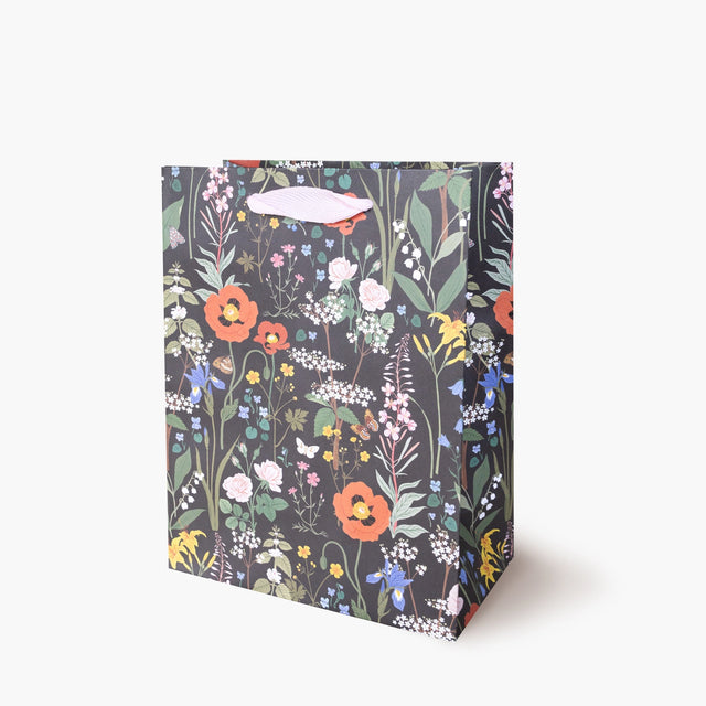 Botanica Paper Co. Medium Gift Bag - Wild Flowers

Heavyweight uncoated paper stock&nbsp;
Printed in full color&nbsp;
Cotton ribbon handles
Cardboard floor insert&nbsp;
Size: 8" x 10.25" x 4.25"