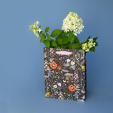 Botanica Paper Co. Medium Gift Bag - Wild Flowers

Heavyweight uncoated paper stock&nbsp;
Printed in full color&nbsp;
Cotton ribbon handles
Cardboard floor insert&nbsp;
Size: 8" x 10.25" x 4.25"