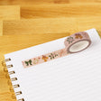 Bows and Bells Washi Tape

Our washi tape is made for paper lovers, pen pals, and anyone who gets butterflies in the stationery aisle. Perfect for journaling, scrapbooking, decorating envelopes, or adding a personal touch to planners and calendars. It's gentle on paper, easy to tear by hand, and removable without leaving residue, so you can rearrange, redo, and re-stick as needed.

Design Features:&nbsp;

Each roll measures 15mm wide on a 10m roll
Full color repeating pattern
Washi tape dispenser packaging
