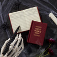 Finally, a pocket-sized place to keep track of your posthumous priorities. Whether it’s petty grudges, unresolved drama, or just a running list of people who deserve a little ghostly mischief, this 2.75” by 3.75” diary is your future haunting blueprint. With 112 gilded-edge pages, it’s the perfect mix of elegance and eerie intent.&nbsp;

Styled with nostalgic flair and a touch of the macabre, this diary channels old-school stationery vibes with just enough spooky sass. It’s ideal for chronicling your spectr