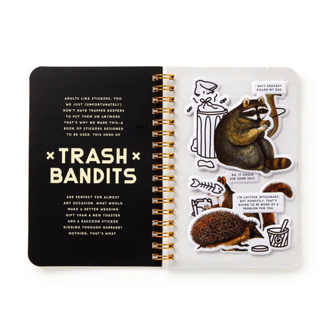 Dumpster chic meets unapologetic attitude in the Trash Bandits Sticker Book—a gloriously messy collection of oversized stickers featuring raccoons, possums, pigeons, and other urban icons with googly eyes and snarky commentary. Whether you're decorating your planner or marking your territory, these critters are here to add some trashy charm to your everyday life.

Inside, you’ll find 18 pages of trash animal stickers + 2 bonus pages of vintage-inspired puffy stickers, all packed with clever quips and chaoti