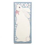 The sweetest little bunny is ready to hold your sweetest notes. Ditsy polka dots and a spray of little white flowers frame the white rabbit. Risograph printed in federal blue and light mauve.