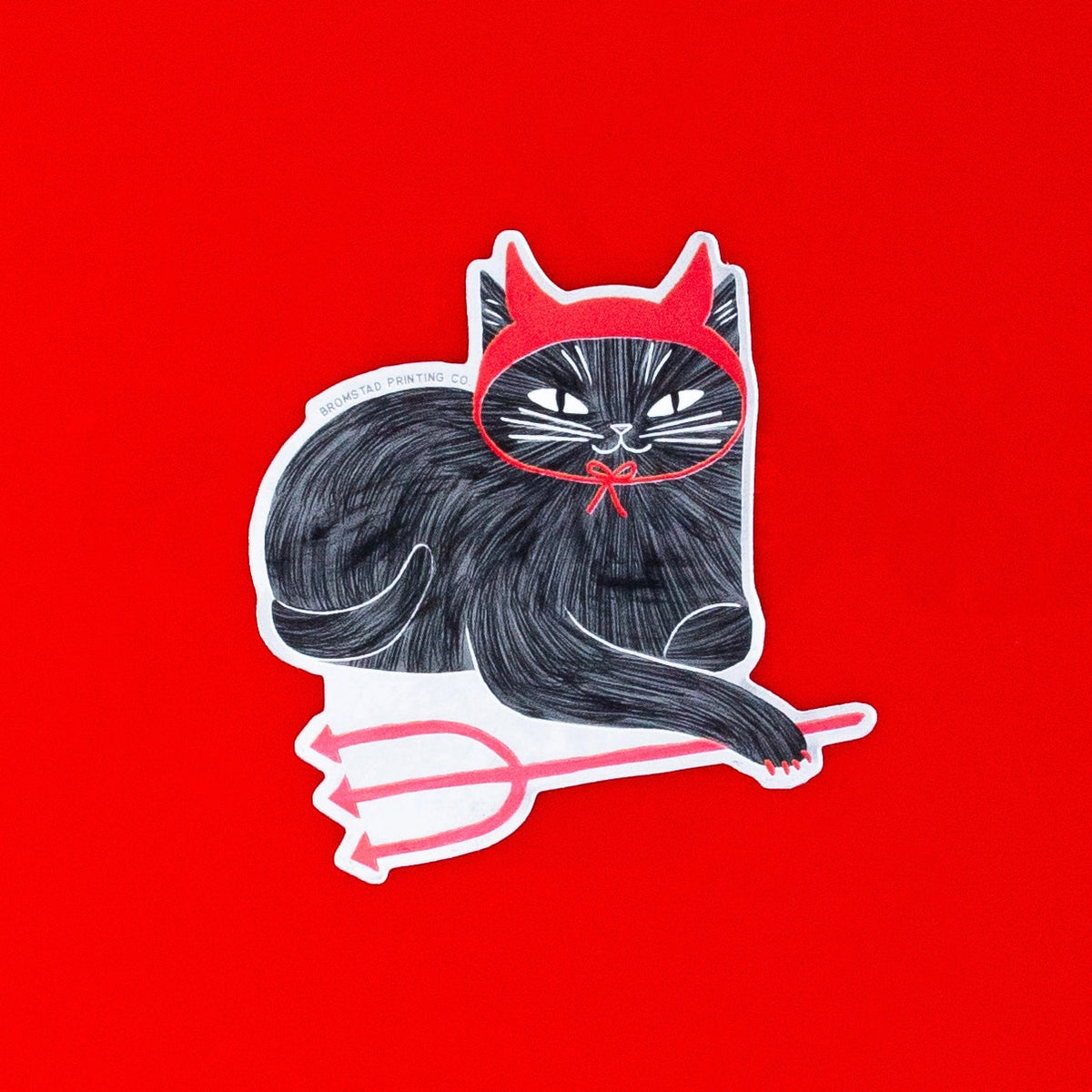 A mischievous cat decked out in devil horns and little pitchfork! This 3" cat sticker is made of a frosted mirror material with shiny red areas, making it purrfect for adorning water bottles, laptops, and more.