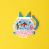 Hello there my fishy friend! A cat watches a goldfish intently, their face refracting goofily through the fishbowl. This 3" clear matte sticker is purrfect for adorning water bottles, laptops, and more. The white lines on the clear sticker pop on colorful backgrounds.