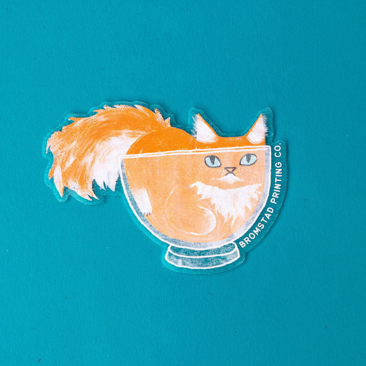 Cats are liquid, we know this. An orange boy has made himself comfy inside a clear glass bowl, fluffy tail and ears protruding. This 3" clear matte sticker is purrfect for adorning water bottles, laptops, and more. The white lines on the clear sticker pop on colorful backgrounds.