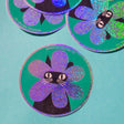 Product description
A black cat with a clipped ear wears a sparkly flower around their face. Truly, the rarest bloom. This 3" super sparkly glitter sticker is purrfect for adorning water bottles, laptops, and more. Watch how it catches the light!