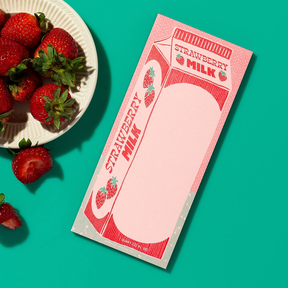 Part of the Quart Collection of charming carton-shaped notepads. Strawberry milk is sweet pink concoction for sweet scribbles. Risograph printed in bright red and seafoam ink on pink paper with red glue binding.