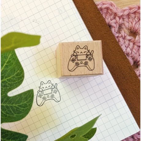 A small wood stamp of a little gamer kitty for your planner and scrapbooking needs. Each stamp measures approximately 1 x 0.75 inch.