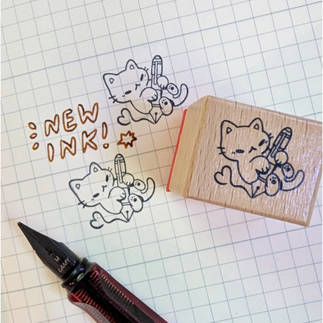 A small wood stamp of a kitty playing with a fountain pen for your planner and scrapbooking needs. Each stamp measures approximately 1 x 0.75 inch.
