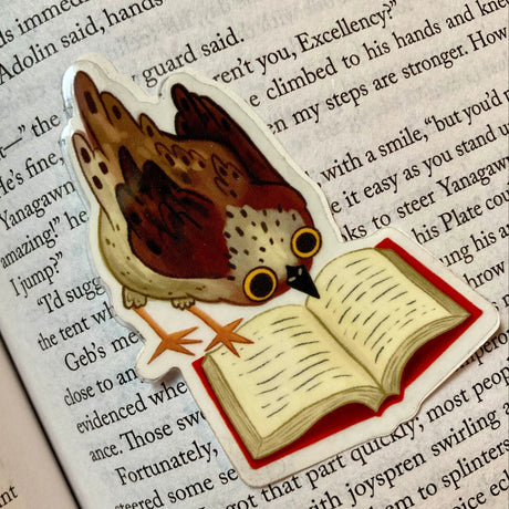 Cute little bird thoroughly engrossed by a very good book. Perfect clear sticker for any book lover.
