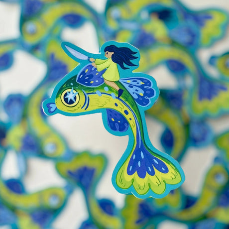 Ride to battle atop a flying fish! A perfect sticker for any fan of whimsy and surrealism.