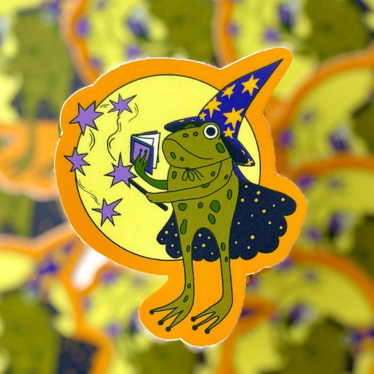 A whimsical little guy — this frog wizard is busy casting a spell.