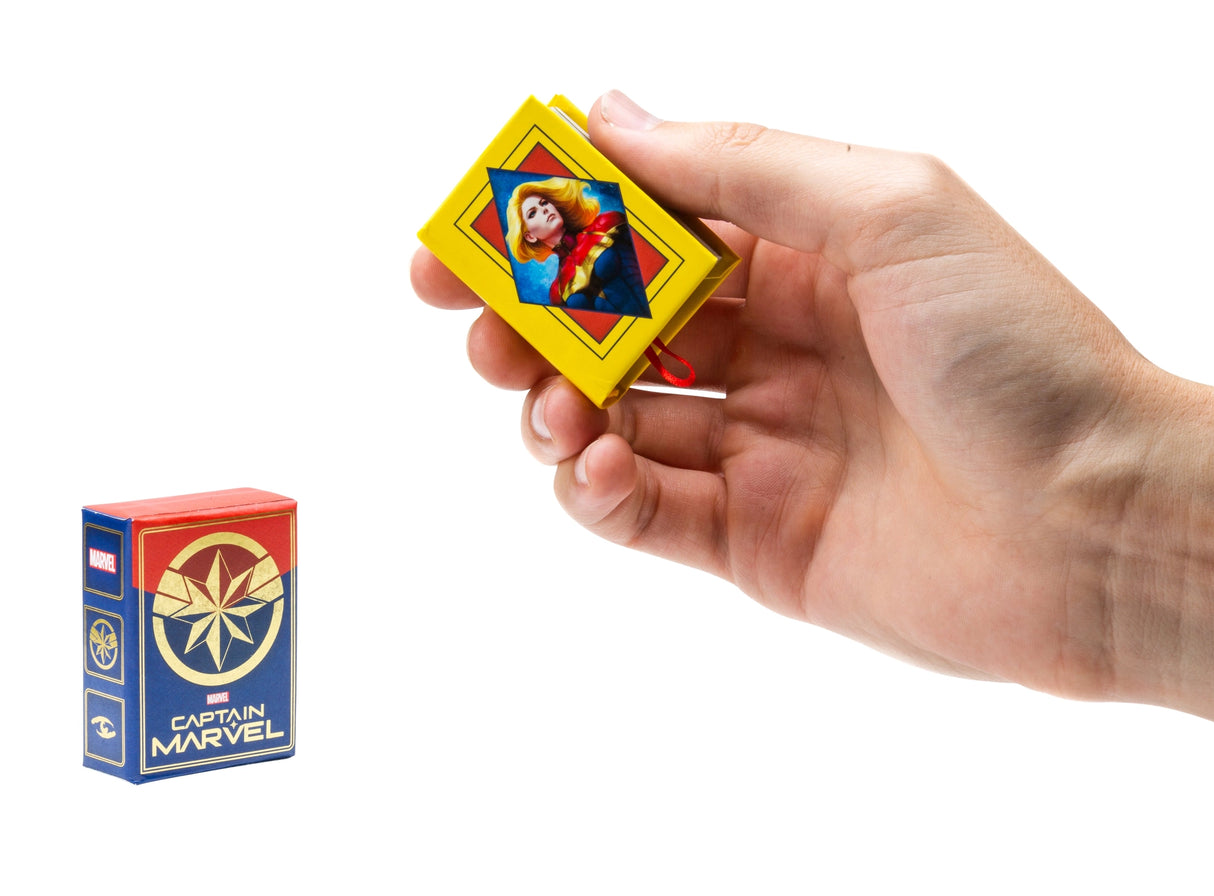 Carol Danvers, the super hero known to all as Captain Marvel, is one of the most powerful beings in the Marvel Universe. Now fans eager to learn more about her amazing adventures can follow her hero’s journey through the pages of this tiny storybook. Summarizing five decades of Captain Marvel’s comic book tales and featuring beautiful art from multiple eras, this unique collector’s item is the perfect gift for any Marvel fan!

AN EPIC SAGA IN THE PALM OF YOUR HAND: Covering 50 years of Captain Marvel’s hero