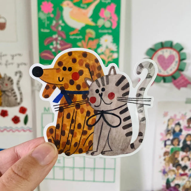 Presenting the CAT&amp;DOG sticker from Daria Solak Illustrations, a must-have for all pet lovers! This sticker, boasting a size of 8 cm, beautifully encapsulates the charm and playfulness of our beloved furry friends. Each design is a product of Daria Solak's meticulous hand-drawn illustrations, promising a unique, artistic flair. Perfect for personalizing your notebooks, gadgets, and more. Enjoy the joy of creativity with this adorable sticker!