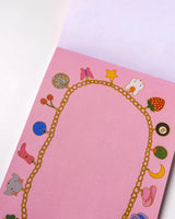 Charmed By Clem Notepad by Clem & Co.

Clem the Bun loves to make charm bracelets for all her friends! However, she kept forgetting which of her friends she had already given them to, so she made a notepad to keep track. Jot down things you don't want to forget either on this charming little notepad!