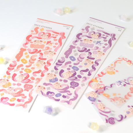 The Cocoroll Sweets deco sticker sheet features Cocoroll surrounded by adorable candies. Available in pink and purple versions, these cute deco stickers are the perfect addition to any polaroids/toploaders, journals, and more. The sparkly holo overlay adds an extra touch of shine and magic.

Dimensions: 2.7” x 8" (6.8cm x 20.5cm)
Quantity: 1 sheet