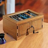 Our dramatic pen case for collectors, with new upgrades to accommodate larger styles. Part of the pleasure of being a pen lover is visual; a certain satisfaction ensues from being able to admire your favorites (and have others do the same). Our Lock and Key Pen Case offers more than an attractive space for displaying your prize pens—it also keeps your collection protected and free from dust. Unlock the wood inlay doors and lift the hinged protective glass lid to reveal the 4 drawers, each with 10 suede-line