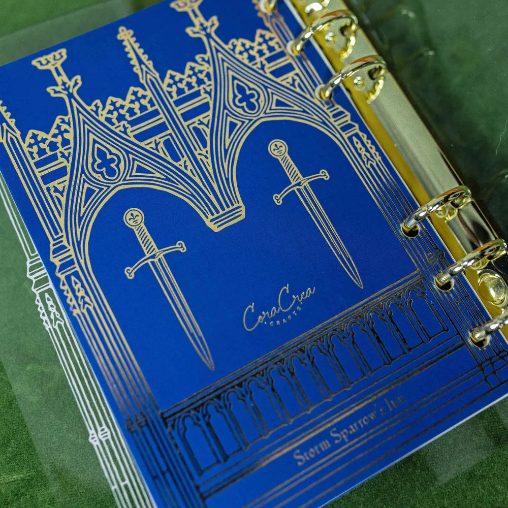 Step into a world of medieval wonder with this charming A6 binder notebook. Adorned with gothic architecture and noble knights rendered in shimmering golden foil, the cover transports you straight to a castle's grand halls.

Inside, a delightful coloring front page invites your creative touch, while 50 pages of luxurious cream 100 gsm paper await your thoughts, sketches, and stories. Perfect for journaling, note-taking, or artistic pursuits with a touch of enchantment.