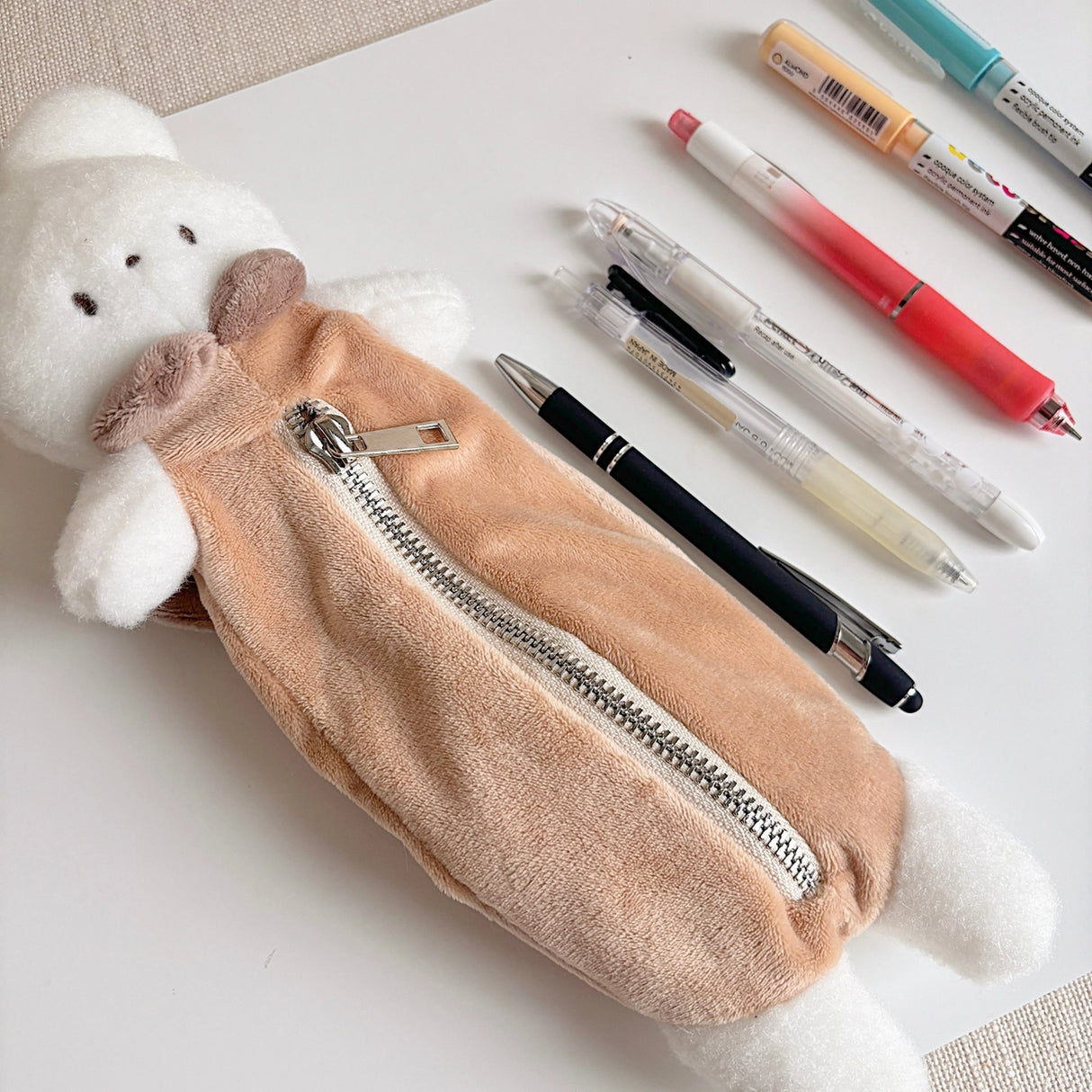 Keep your pens, pencils, and small essentials organized with this soft and fuzzy pencil pouch! With approximately 5.5 inches of storage space, it's perfect for carrying stationery, makeup brushes, or other daily must-haves. Its compact and lightweight design makes it easy to slip into your bag, while the sturdy zipper closure keeps everything secure.