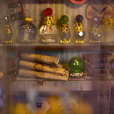 Build your own enchanted apothecary with this Magic Shop DIY kit-a charming miniature store packed with mysterious potions, glowing vials, and shelves brimming with spellbooks, recipe tomes, and dusty old encyclopedias. Every detail tells a story: bubbling brews, glowing glass jars, stacks of arcane books, and secret scrolls tucked into cozy corners.

2 AAA batteries required; batteries are not included.
Ages 14+
322 pieces
Assembled size: 4.5 x 3.9 x 7.4 inches