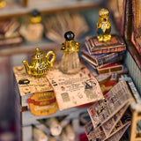 Build your own enchanted apothecary with this Magic Shop DIY kit-a charming miniature store packed with mysterious potions, glowing vials, and shelves brimming with spellbooks, recipe tomes, and dusty old encyclopedias. Every detail tells a story: bubbling brews, glowing glass jars, stacks of arcane books, and secret scrolls tucked into cozy corners.

2 AAA batteries required; batteries are not included.
Ages 14+
322 pieces
Assembled size: 4.5 x 3.9 x 7.4 inches