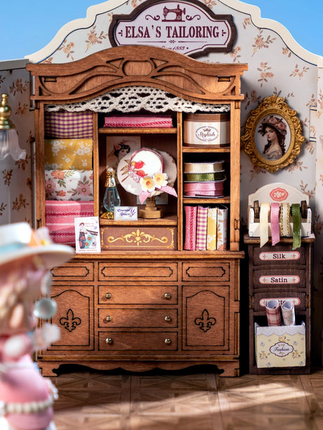 Immerse yourself in the delicate artistry of tailoring with this exquisite DIY miniature kit. Featuring finely crafted rolls of fabric, graceful ribbons, and an elegant dress poised upon a classic dress form, this kit invites you to create a sophisticated and enchanting tailor's room. Perfect for those who appreciate intricate craftsmanship, it beautifully captures the timeless charm of a bespoke workspace in miniature.

2 AAA batteries required; batteries are not included.
Ages 14+
322 pieces&nbsp;
Assembl