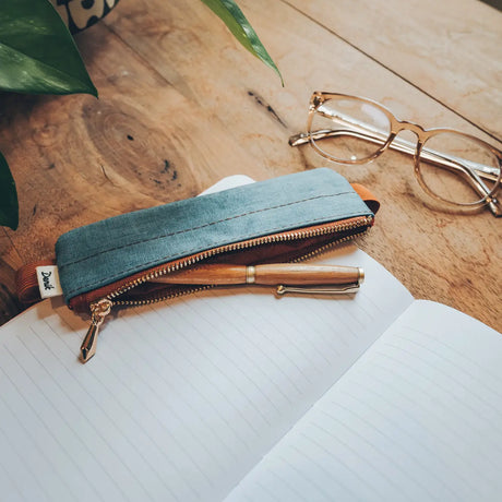 Denim Distressed Blue Notebook Pouch

Keep your go-to notebook and must-have pens together with our Denim Blue Notebook Pouch (honestly, we should’ve made these sooner). Designed with a fabric front, PU back, and a fully nylon-lined interior, it features an elastic band that fits snugly around most notebooks—so you’re ready for everyday ideas on the go.

Vegan Leather Pouch with Zipper
Elastic Fits Books up to 9" High
Zipper closure
9" x 3.75"